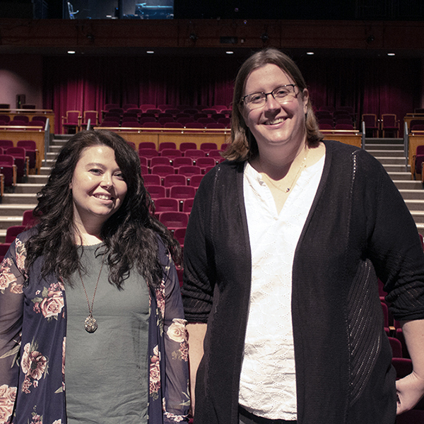 Two women stand in the Tarkington theater.